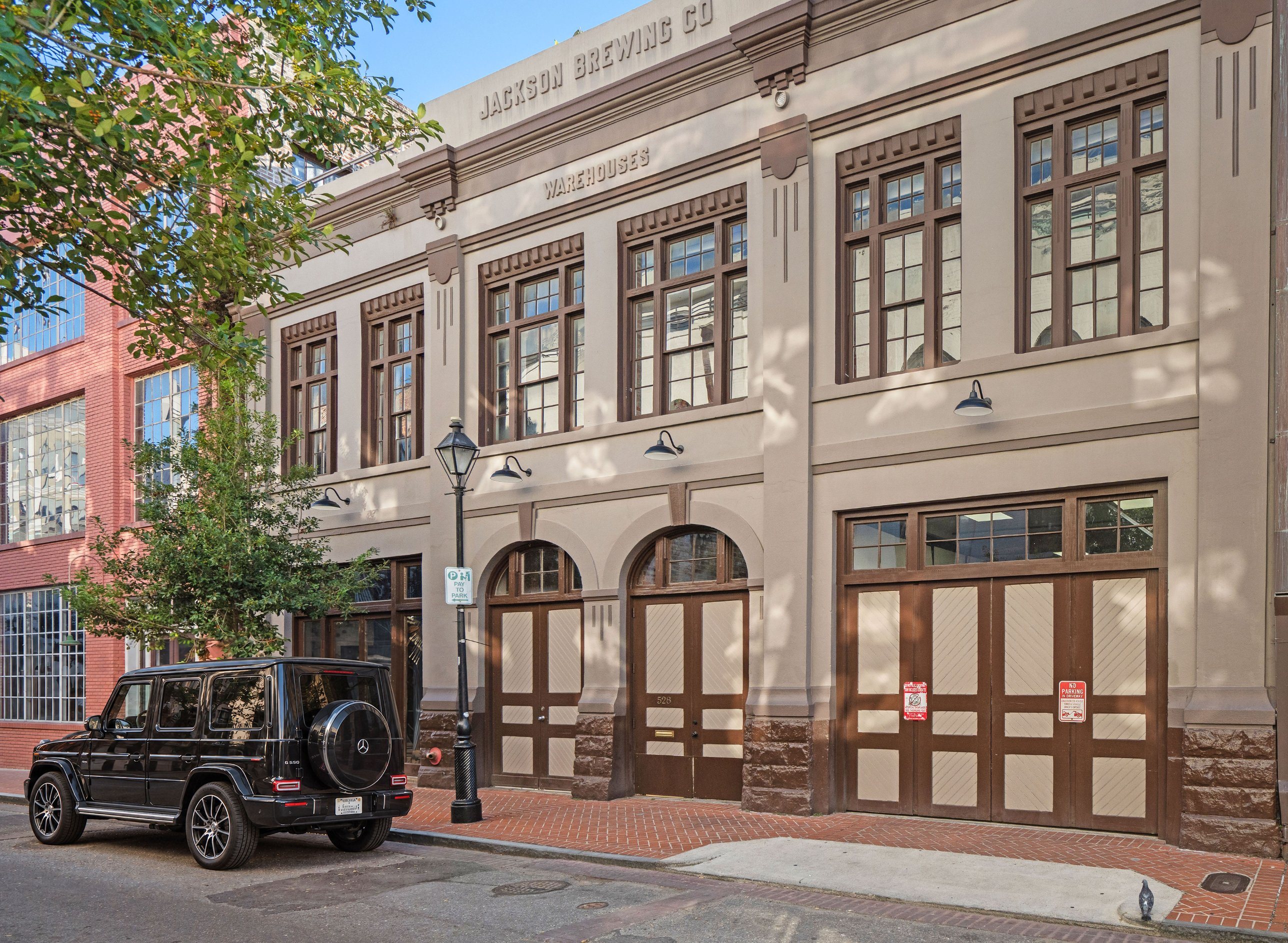 The Wilkinson Street front, with arched entries and carriage doors, 528 Wilkinson Street